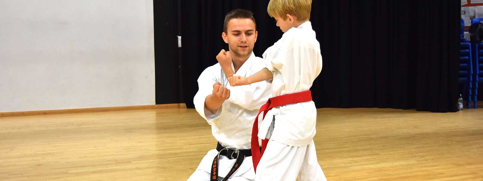 Sensei Steven Connell helping a younger Bristol Karate Academy student